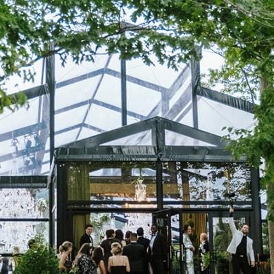 Guests file in to a greenhouse-style venue