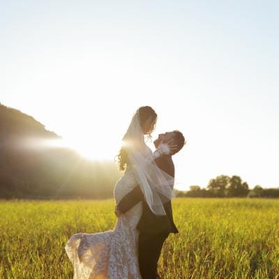 Morgan and Anthony pose in the mustard field of Tar Creek Ranch on their wedding day