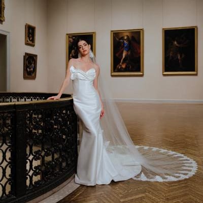 Model poses in bridal gown amidst artwork at Minneapolis Institute of Art