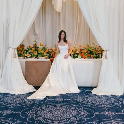 Model poses in front of boldly styled reception table at The Sentinel