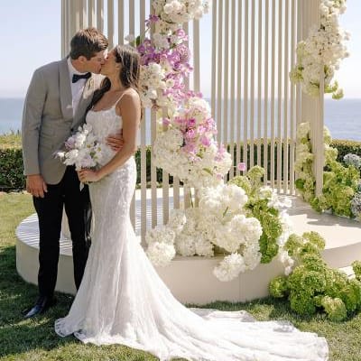 Ella and Caden share a kiss by their custom made modern altar 