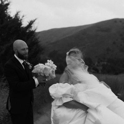 Jenni and Coby get caught in the rain during portraits at Dismal River Club