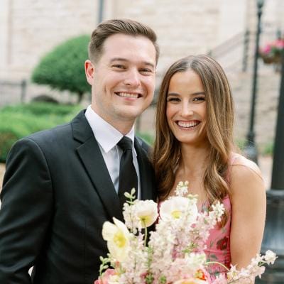 Bride and groom pose together on their winning wedding day