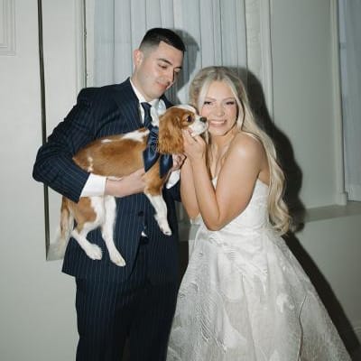 Keland + Dillon posing with their beloved king charles dog