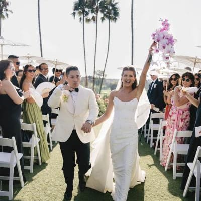 Jordin and Allan cheer as they walk back down the aisle 