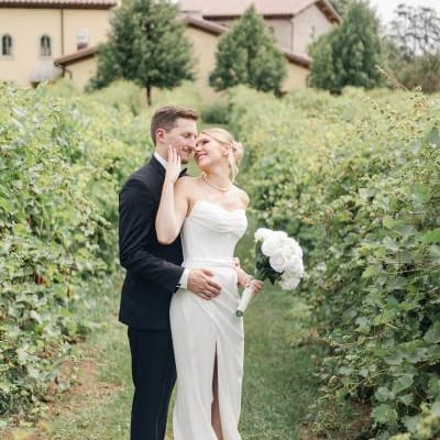 Layne and Nick pose in their wedding attire on the grounds of Villa Bellezza