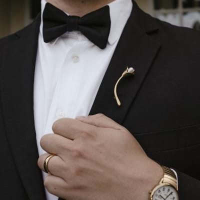 Close up of brooch on lapel of tuxedo