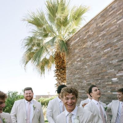 Groomsmen smile and pose playfully 