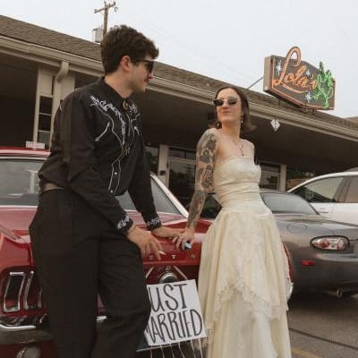 Bride and Groom pose outside of their restaurant wedding day 
