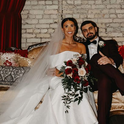 Kara and Jordan pose on a lounge vignette on their wedding day