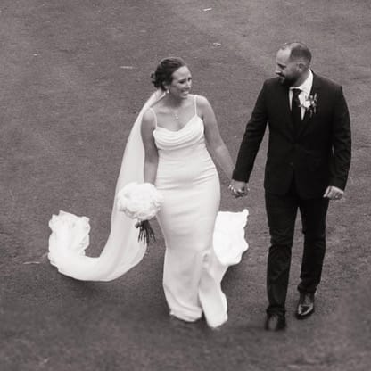 Kayla and Clint walk on the green of Fremont Golf Club on their wedding day