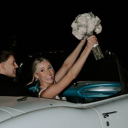 Madison and Sam in their vintage getaway car