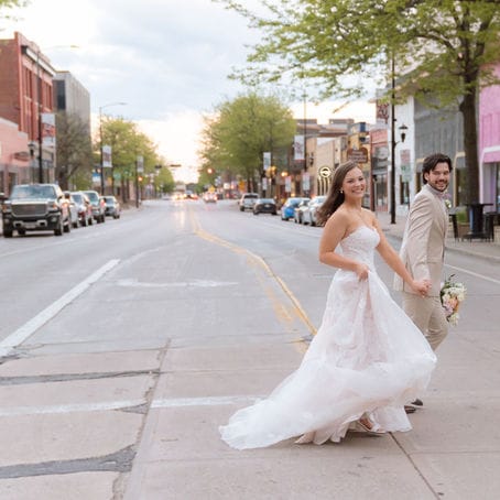 Madelyn and Andrew cross the street outside of Gather on Broadway