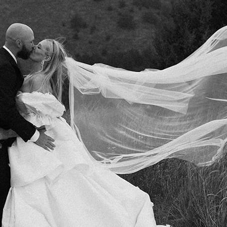 Jenni and Coby get caught in the rain during portraits at Dismal River Club
