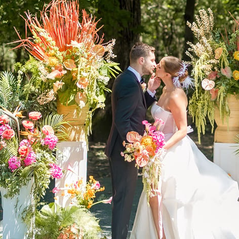 Birds of Paradise and tropical florals in lush altar space framing couple in Palm Springs-inspired editorial at Equestria West