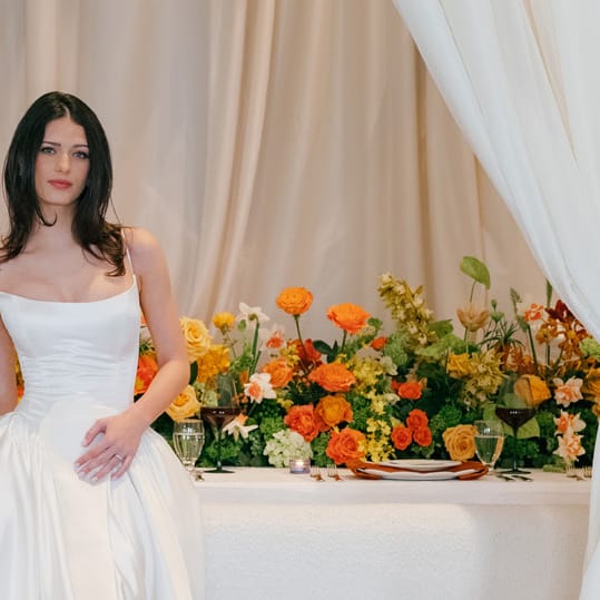 Model poses in front of boldly styled reception table at The Sentinel