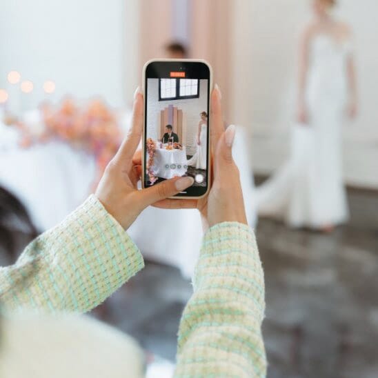 Content creator taking candid video of a bride
