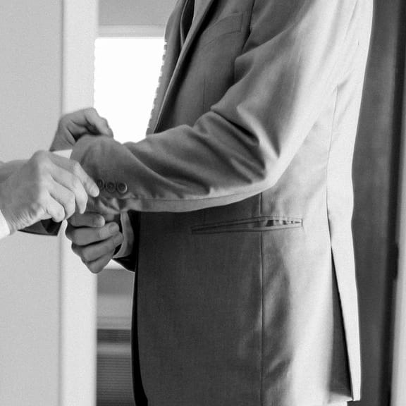 Jonathan and Robbie help each other dress for their wedding day
