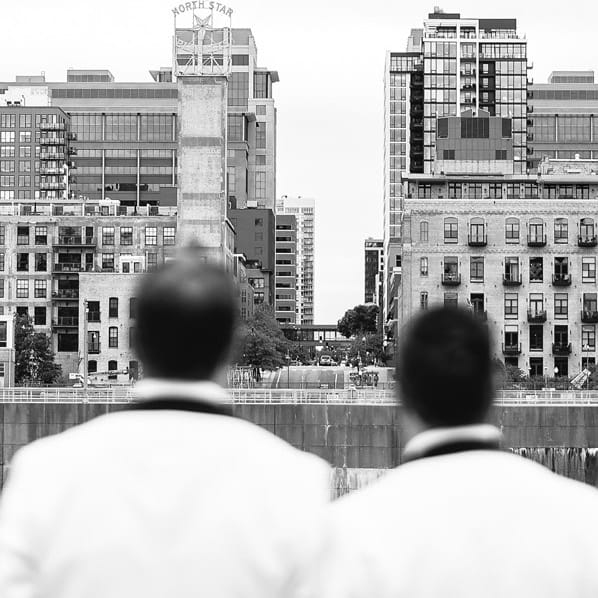 Matt and Luke lean on each other against the Minneapolis skyline