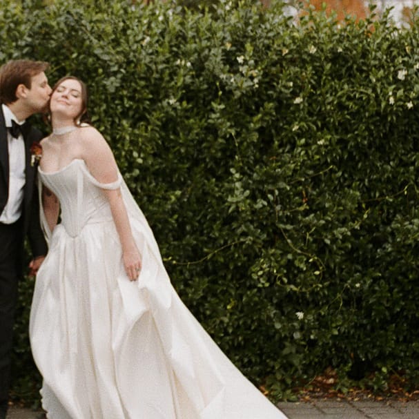 Allie and Max pose side by side on their wedding day