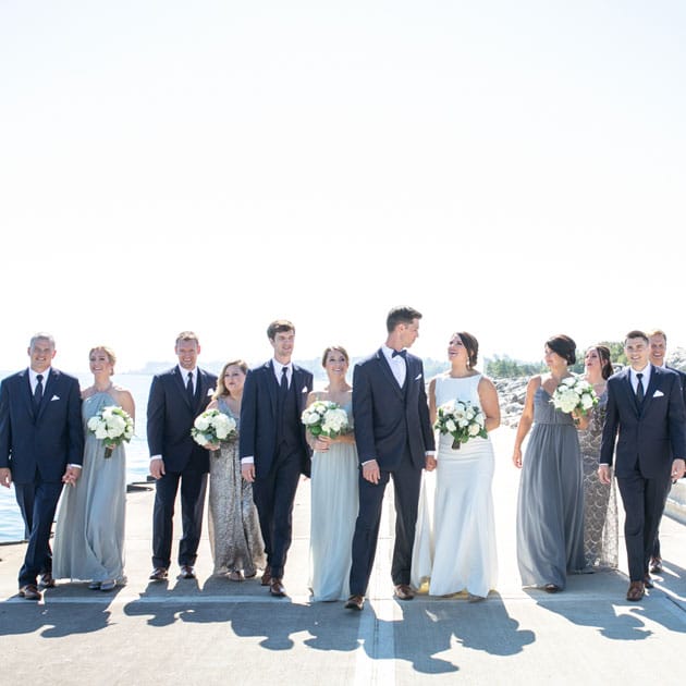 The bridal party stands along the water of Lake Michigan for their portraits