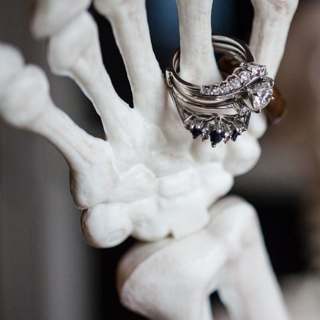 A skeleton displays the bride's rings at the entrance to Mayowood Stone Barn