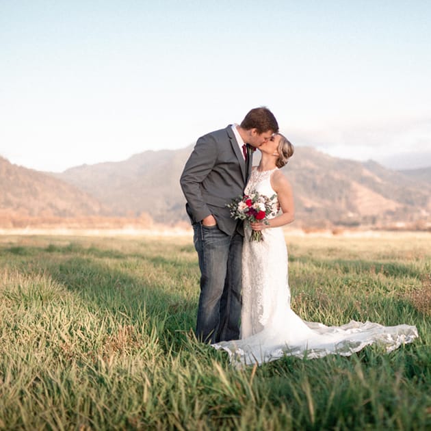 Hayley and Luke kissing after their ceremony on the family farm in Tillamook, Oregon.