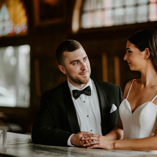 The couple poses at the bar of The Commodore