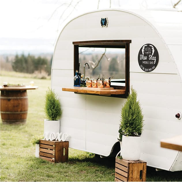 Wine barrel bistro tables give guests a place  to congregate with their drinks