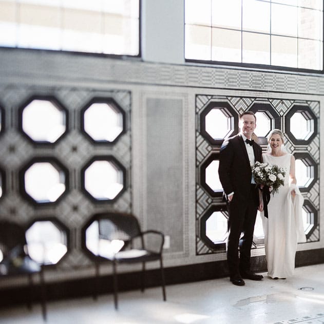 Emily and Phil brightened a historic space with greenery and sparkling candlelight for their family-filled day