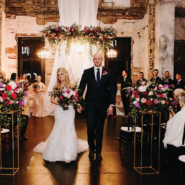 Molly and Seth walk down the aisle during their wedding at Aria.
