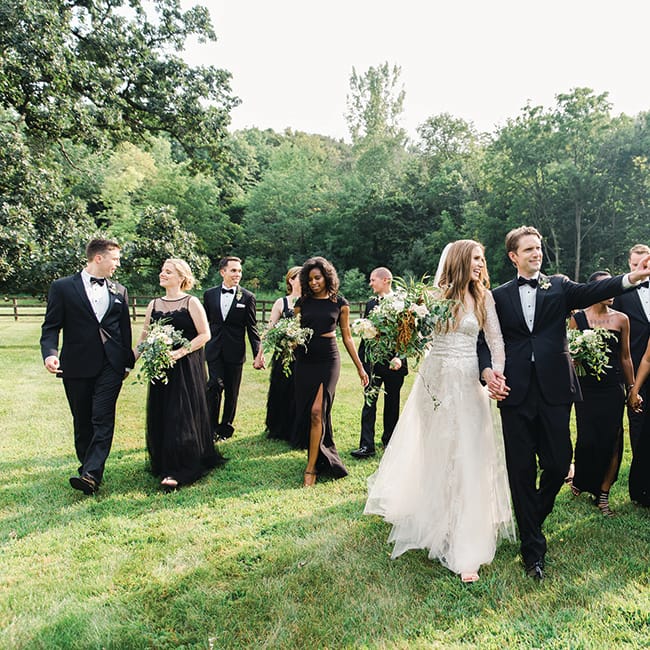Laura, Rob and their wedding party walk the grounds at Mayowood Stone Barn