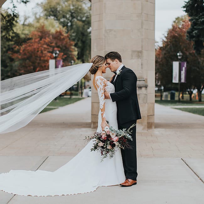 Ashley and Anthony embrace on their wedding day at the University of St. Thomas