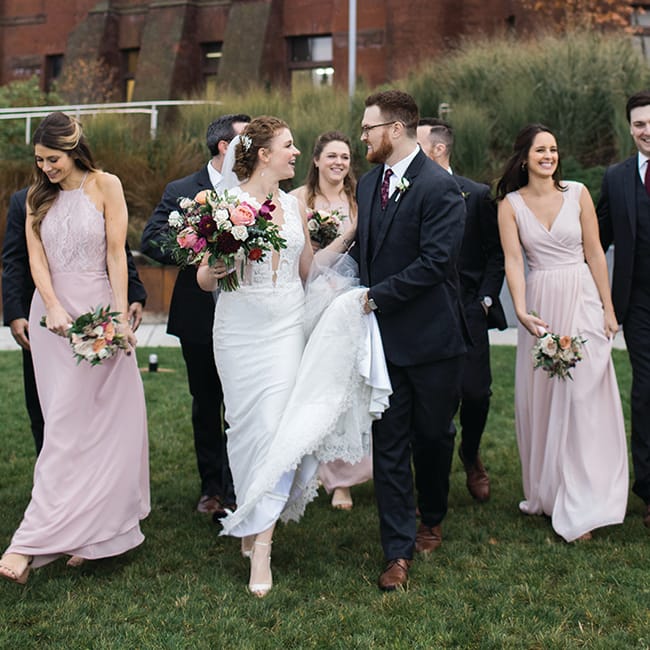 Jayme Udvare and Peter Letarte walk with their wedding party.