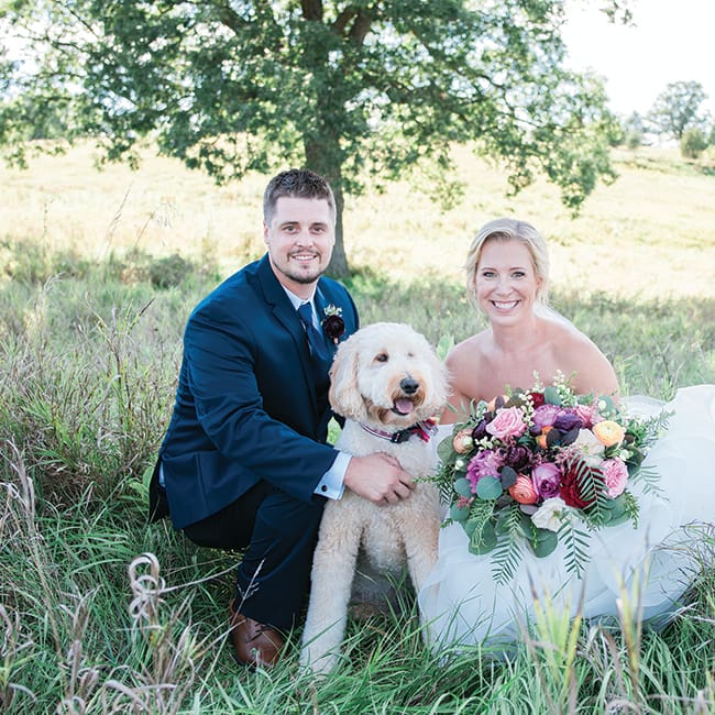 Carrie Seibel and Zach Fisher pose with their dog at St. Anthony on the Lake.
