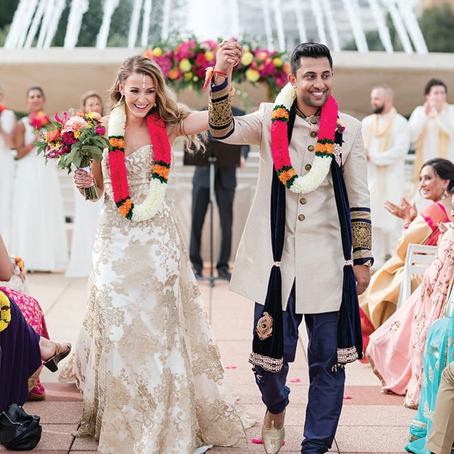 Molly Stiffler and Bobby Syal walk down the aisle at Monona Terrace.