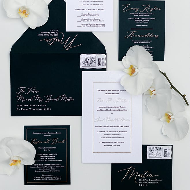 A details photo featuring black and white wedding invites.