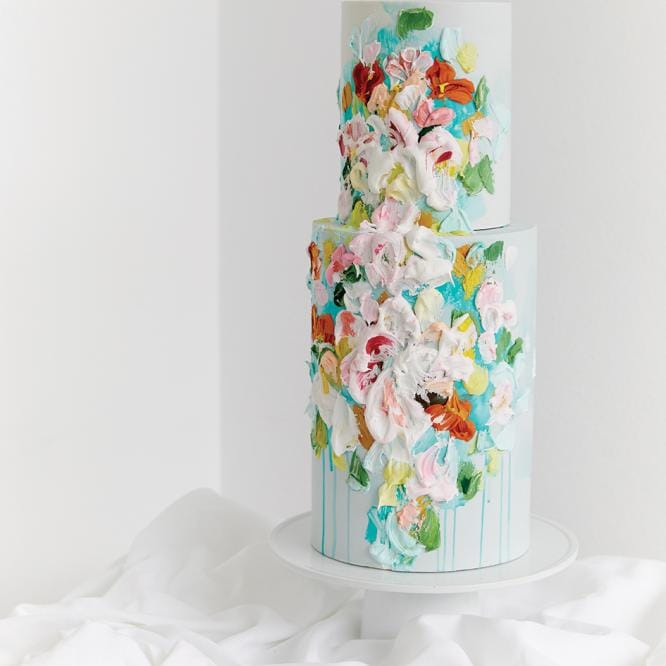 Modern wedding cake with artistic splashes of color in bright, floral hues.