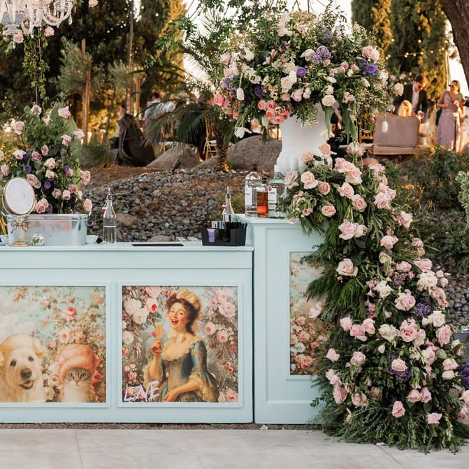 Outdoor bar decorated with flowers and a custom bar wrap