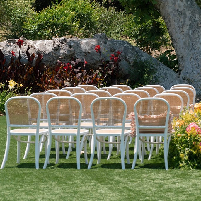 Outdoor ceremony set up featuring peachy florals on the grounds of Monserate Winery