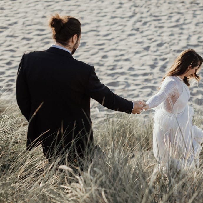 Rachel and Nate run to the beach near Proposal Rock for their first look