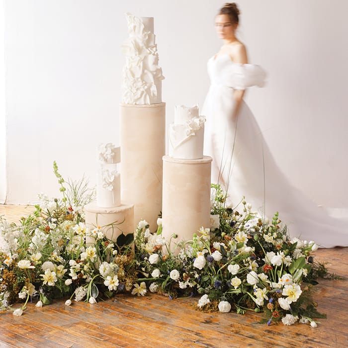 Chic and Elegant Wedding Cakes Displayed Amongst Fresh Florals