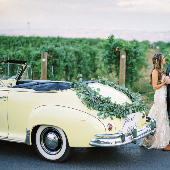 Afton and Liam at Basel Cellars with their vintage convertible getaway car.