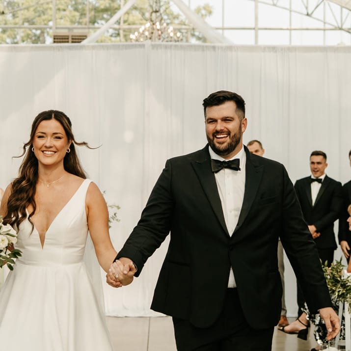 Lauren and Nathan walk back down the aisle after exchanging vows at Greenhouse No 7