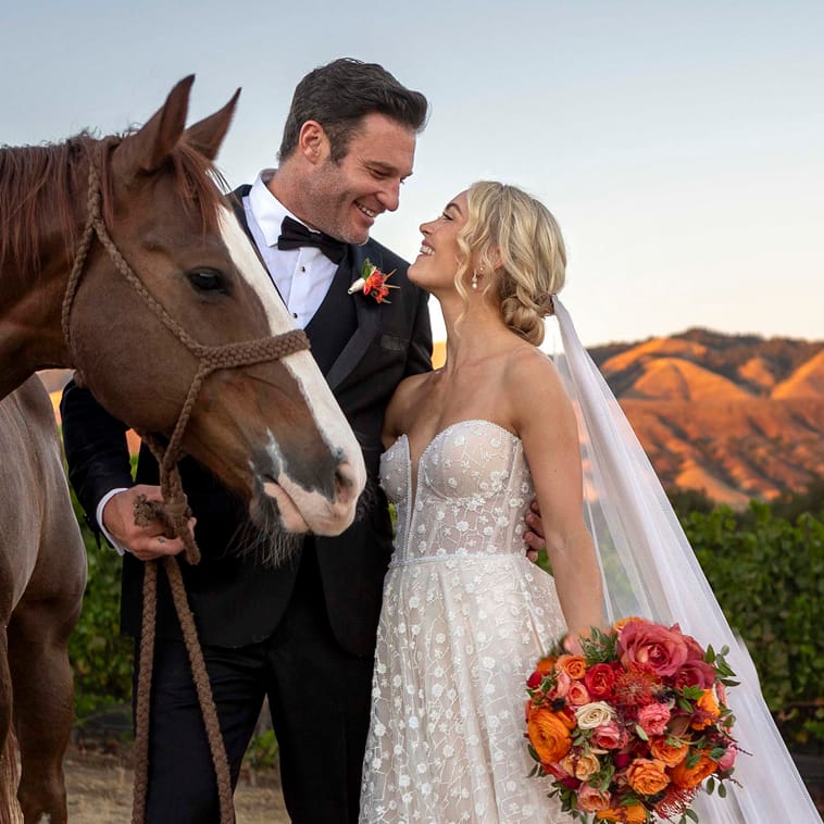 Bride and groom pose with a horse at sunset on La Lomita Ranch
