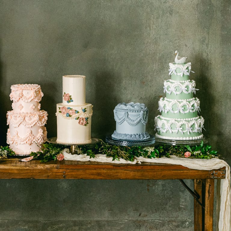 Five different vintage-style Lambeth cakes at wedding cake shoot with delicate details