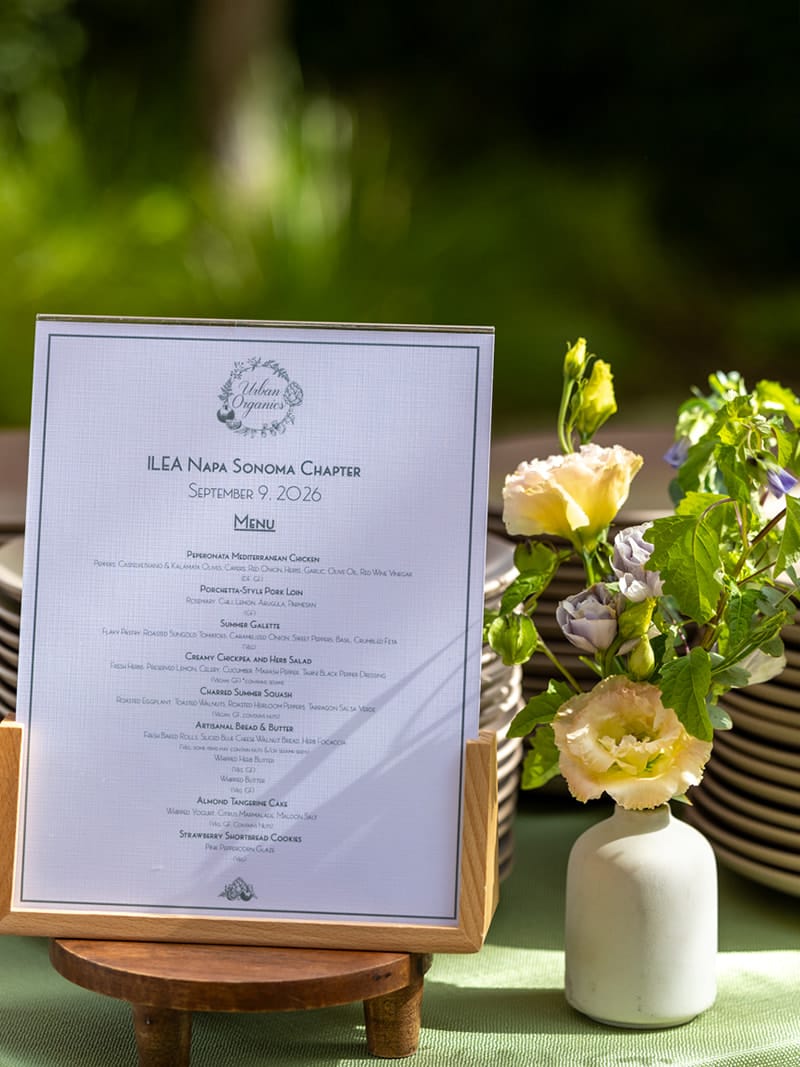 Event menu displayed beside place settings and floral arrangements at Rodney Strong Vineyards