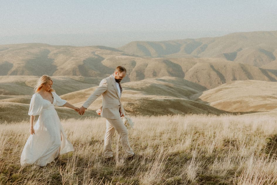 couple walking through field