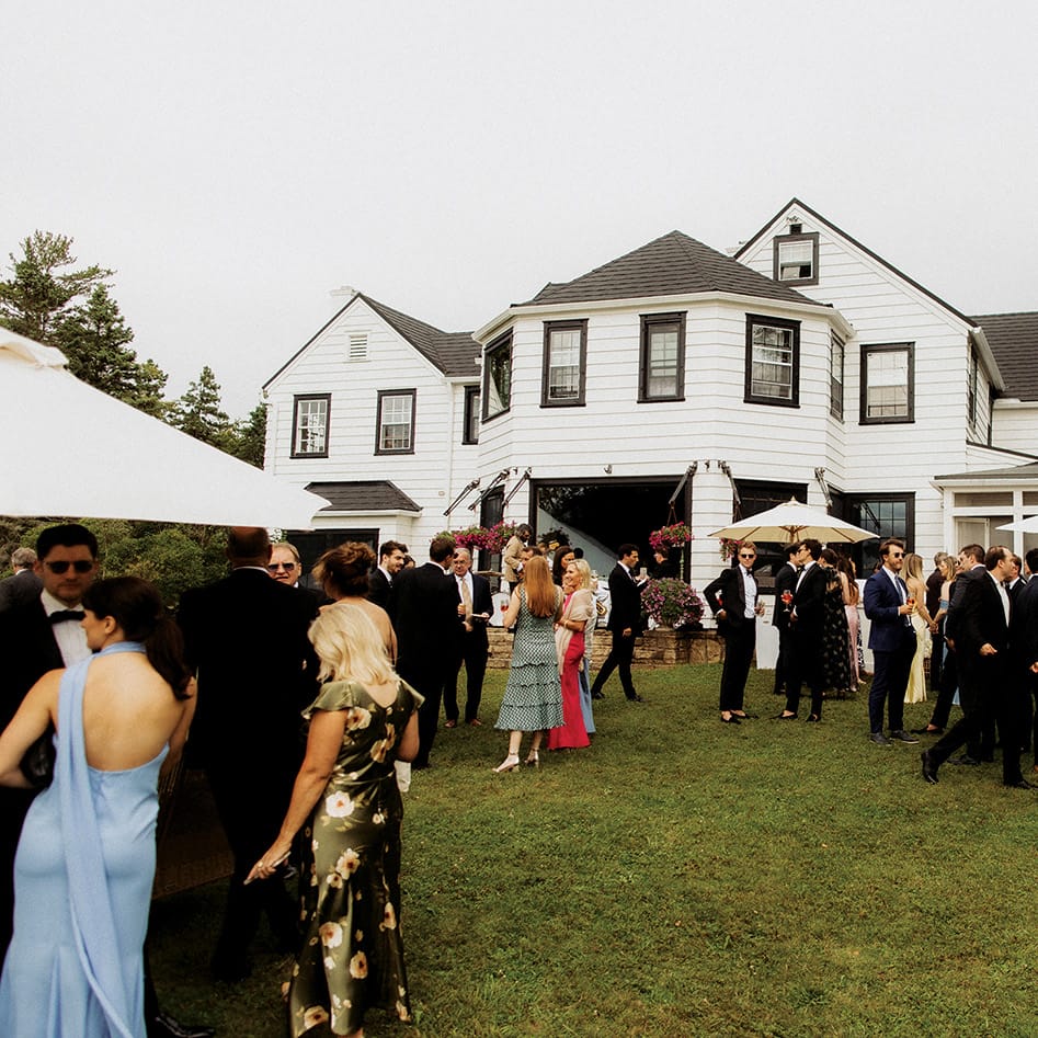 Lively cocktail hour unfolds on the back lawn of the Island Estate on Madeline Island