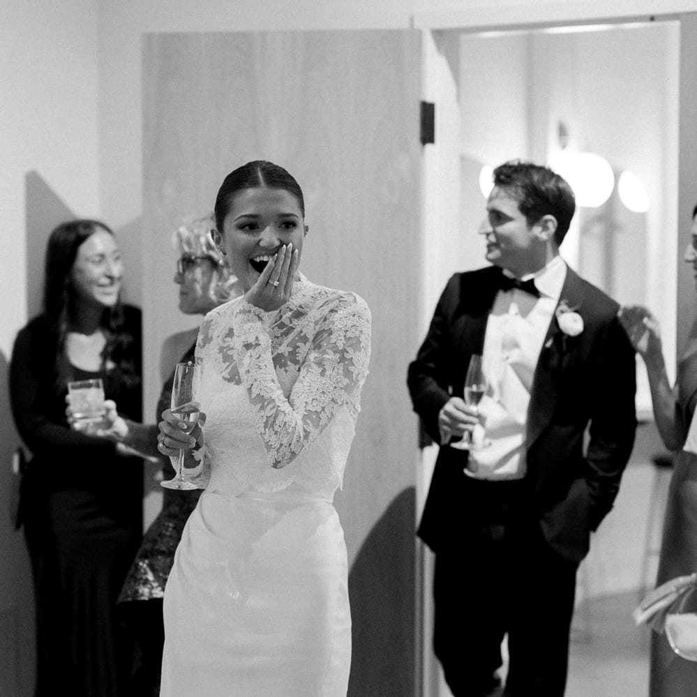 Bride and groom smile in suprise and awe of their wedding reception at The Whim
